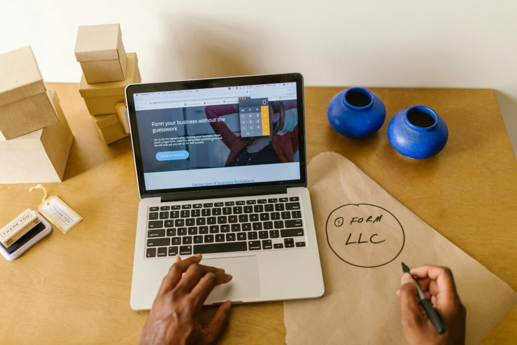 pexels-kampus-7289719.jpg - Entrepreneur working on laptop planning small business ideas under an LLC in 2025